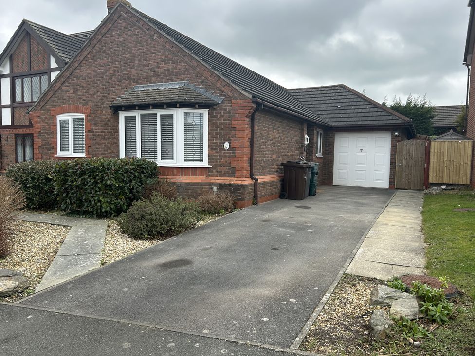 A house with a driveway and garage at 40 Gloddaeth View in Llandudno