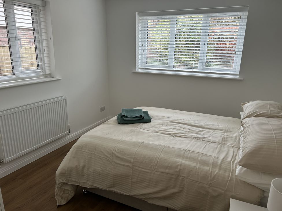 A bedroom with a bed and towels at 40 Gloddaeth View in Penrhyn Bay