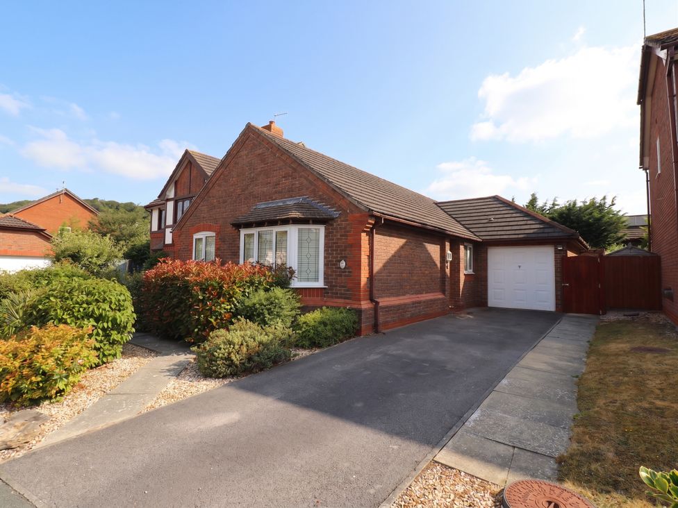 A house with a driveway and garden at 40 Gloddaeth View in Penrhyn Bay