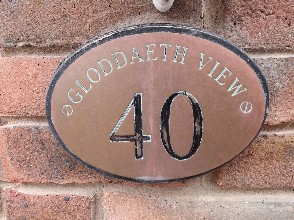 A plaque displaying the address 40 Gloddaeth View on a brick wall at 40 Gloddaeth View Penrhyn Bay