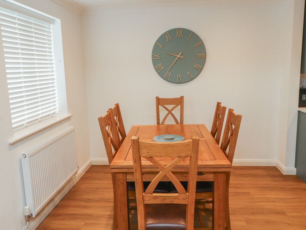 A dining room with a table and chairs at 40 Gloddaeth View in Penrhyn Bay