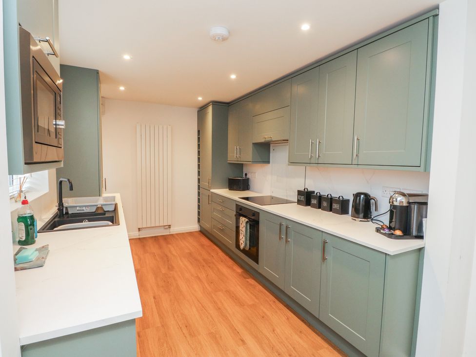 A kitchen with a sink and countertop at 40 Gloddaeth View Penrhyn Bay