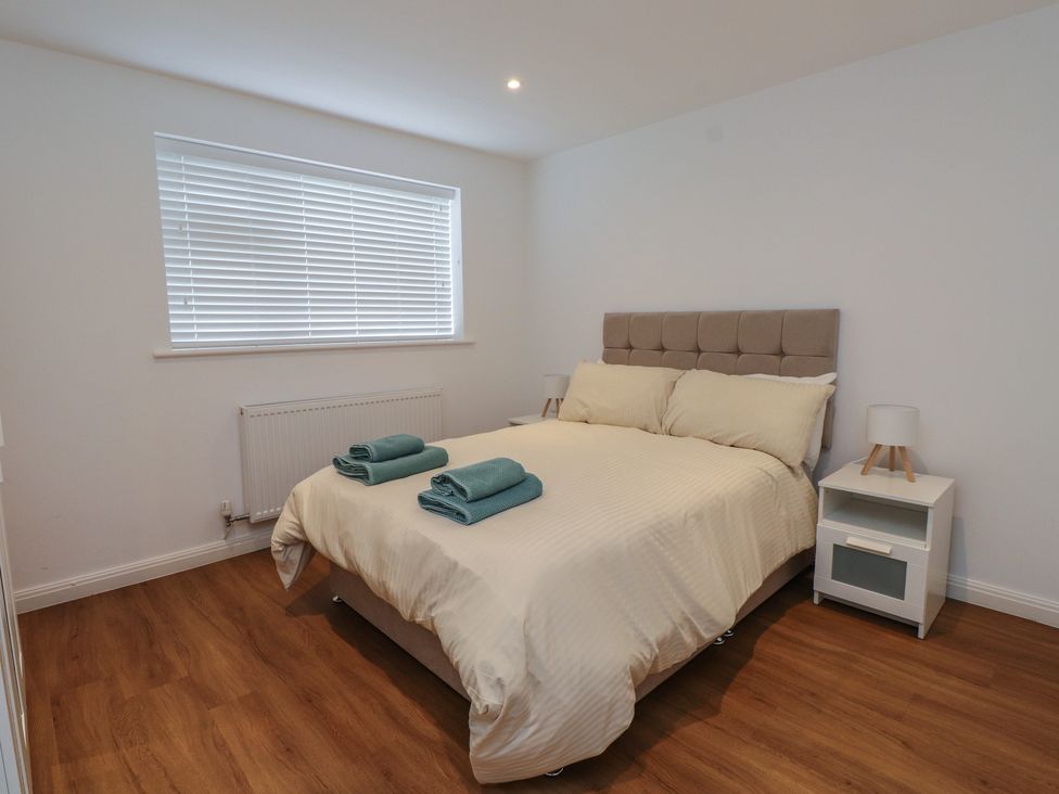 A bedroom with a bed and towels at 40 Gloddaeth View in Penrhyn Bay