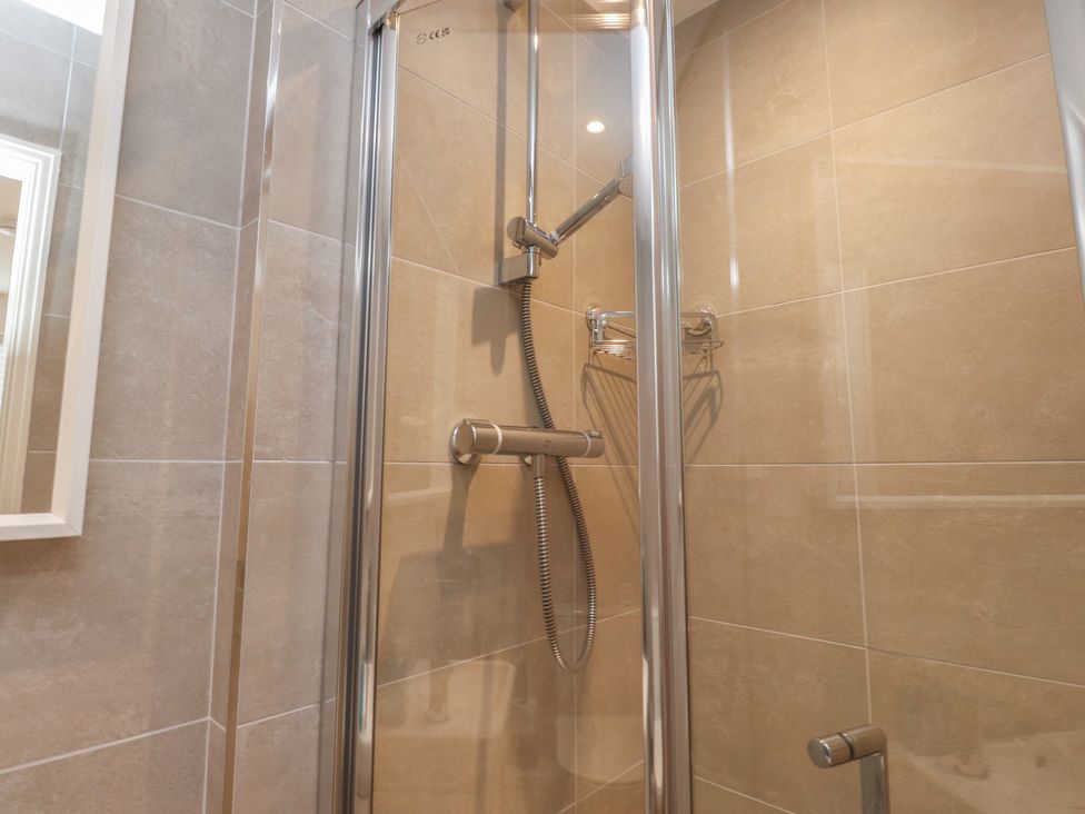 A shower with glass door in a bathroom at 40 Gloddaeth View Penrhyn Bay