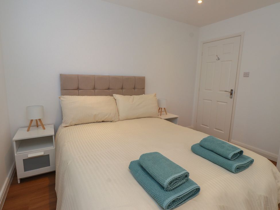 A bedroom with a bed and bedside table at 40 Gloddaeth View in Penrhyn Bay
