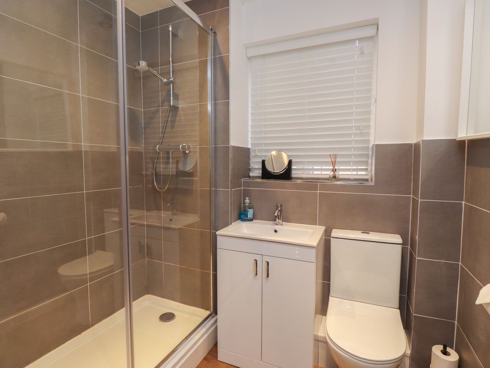 A bathroom with shower and sink at 40 Gloddaeth View Penrhyn Bay