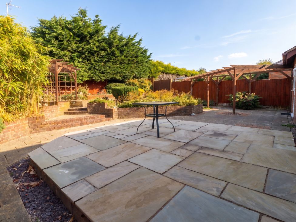 A garden with seating area and landscaping at 40 Gloddaeth View Penrhyn Bay