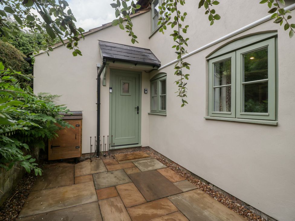An outdoor area with a green door and windows at 2 Loxter Villas Wellington Heath near Ledbury
