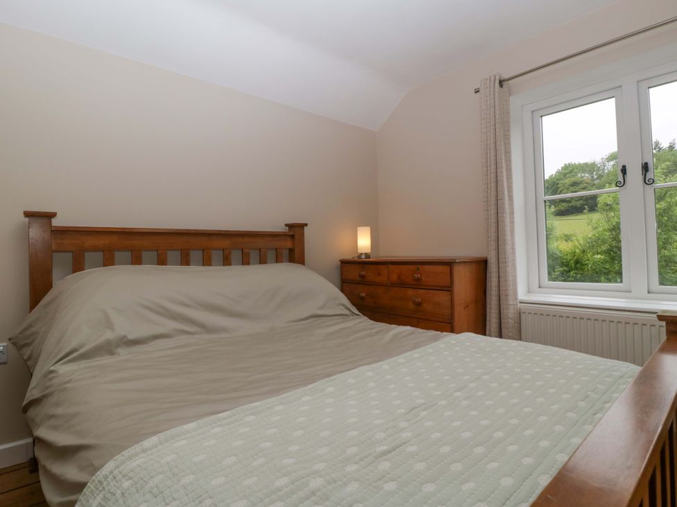 A bedroom with a bed and chest of drawers at 2 Loxter Villas Wellington Heath near Ledbury