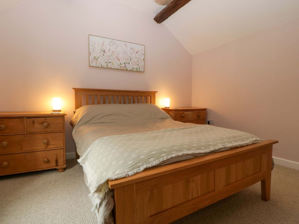 A bedroom with a bed and nightstands at 2 Loxter Villas Wellington Heath near Ledbury