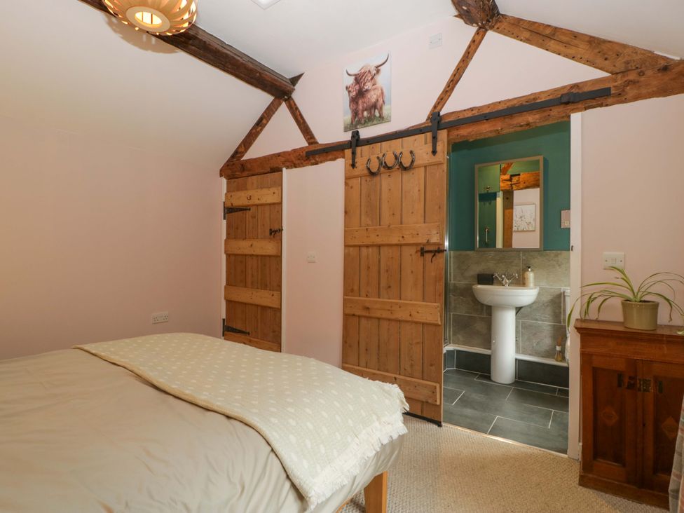 A bedroom with a bed and an attached bathroom at 2 Loxter Villas Wellington Heath near Ledbury