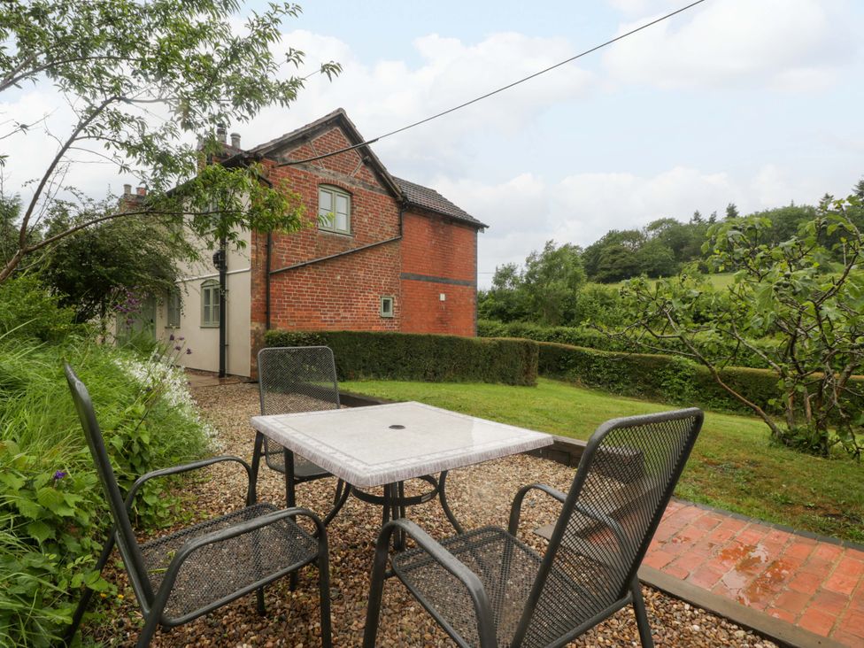 A garden with a table and chairs at 2 Loxter Villas Wellington Heath near Ledbury