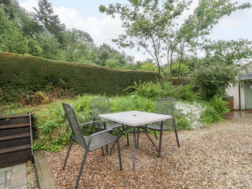A table and chairs in a garden at 2 Loxter Villas Wellington Heath near Ledbury