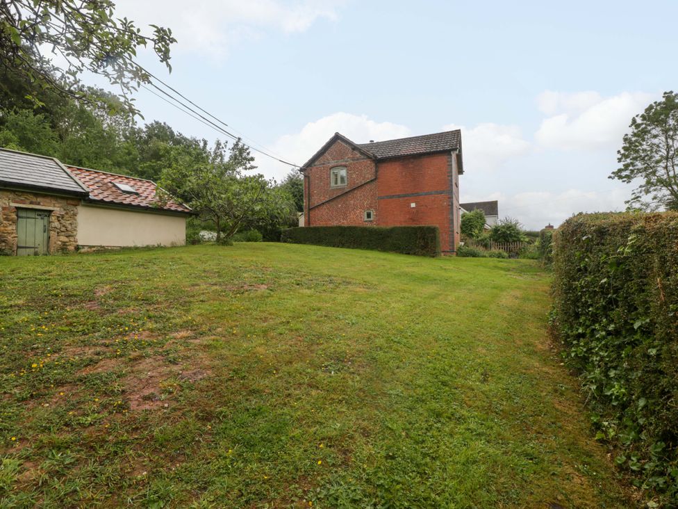 A view of a house and shed in a grassy area at 2 Loxter Villas Wellington Heath near Ledbury