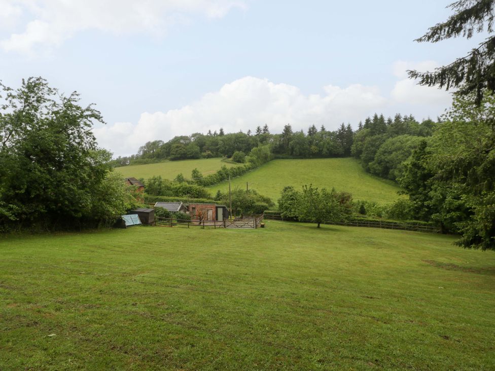 An outdoor area with grass, trees, and a hill at 2 Loxter Villas Wellington Heath near Ledbury