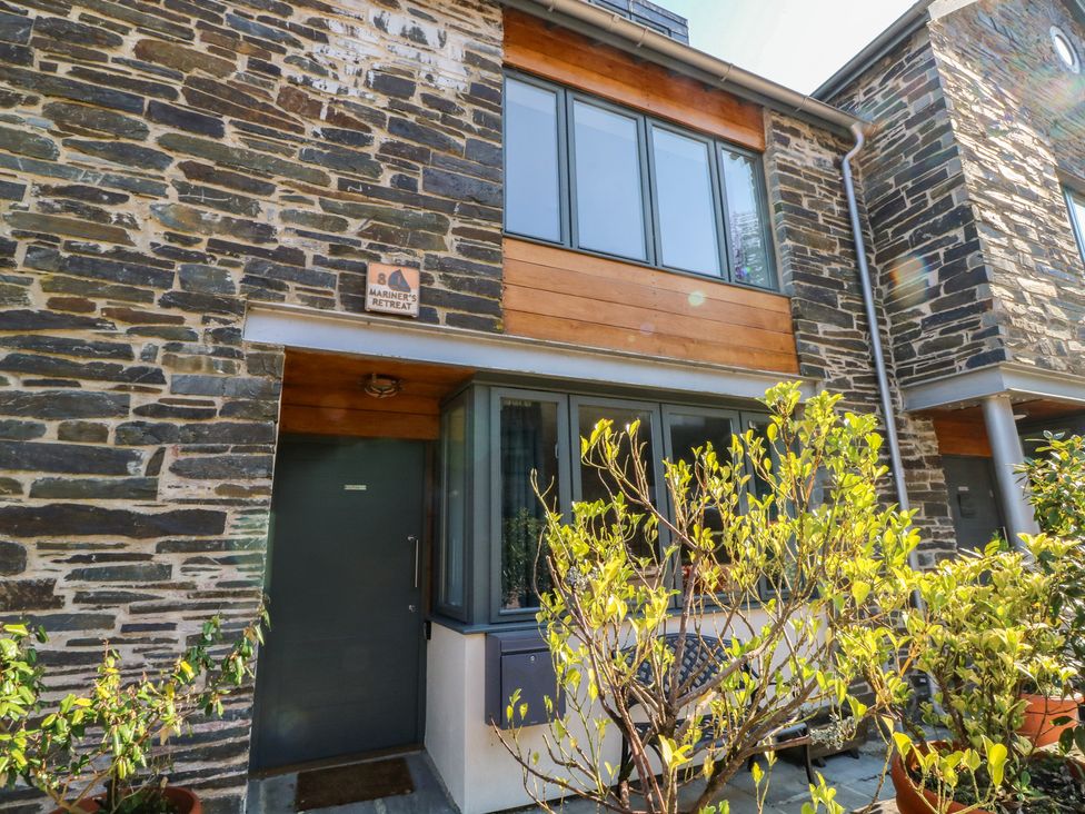 A modern stone building exterior with plants at 8 Pottery Cottages