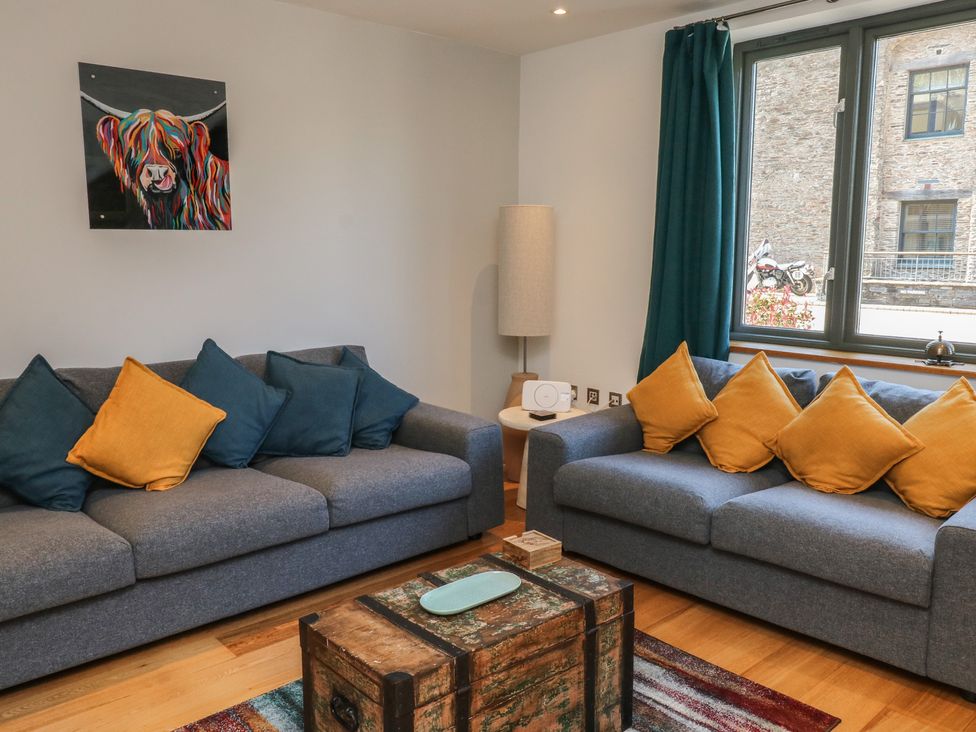 A living room with sofas and a coffee table at 8 Pottery Cottages