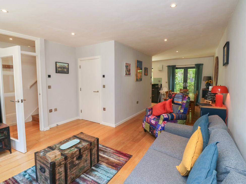 A living room with a sofa and coffee table at 8 Pottery Cottages