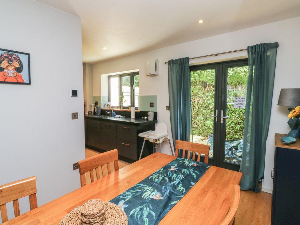 A dining room with a wooden table and chairs at 8 Pottery Cottages 