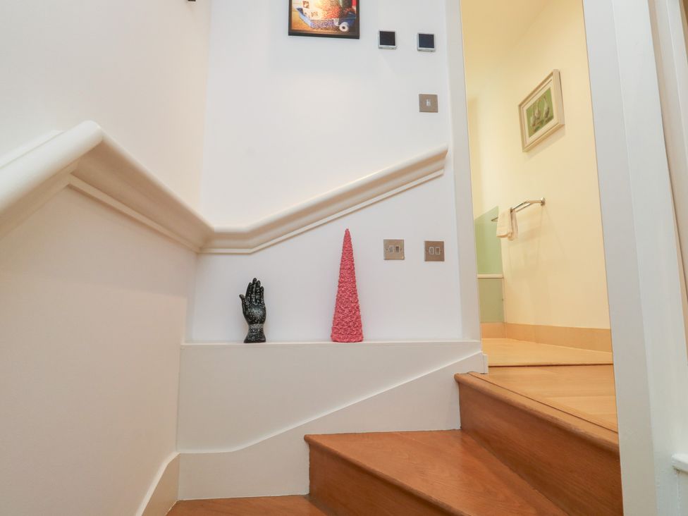 A staircase with a hand statue and a decorative cone at 8 Pottery Cottages