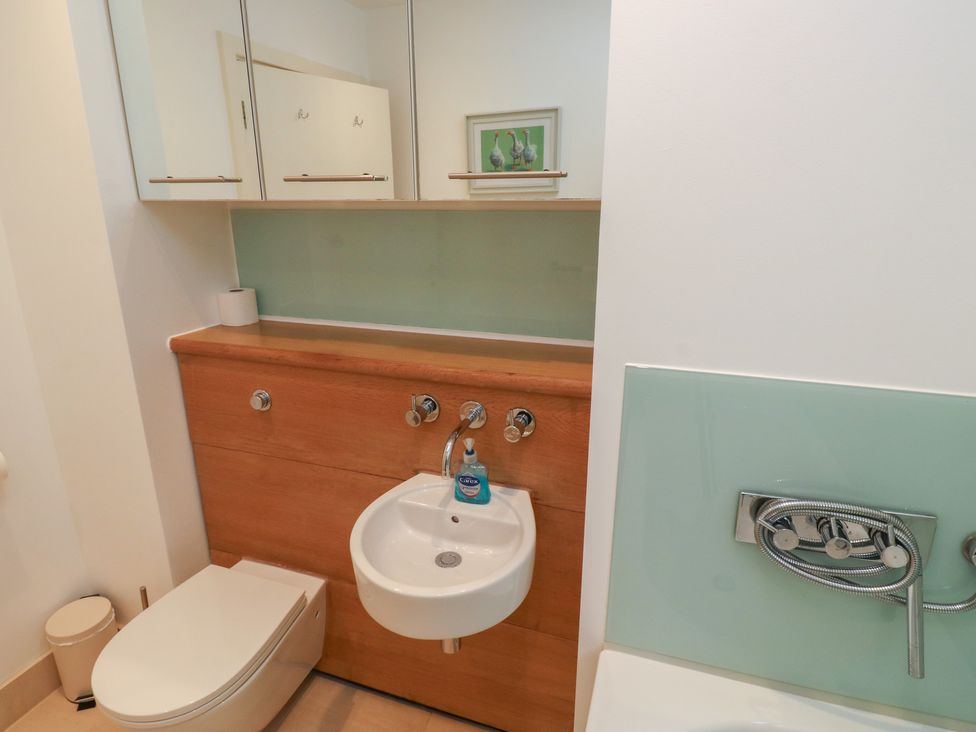 A bathroom with a sink and toilet at 8 Pottery Cottages
