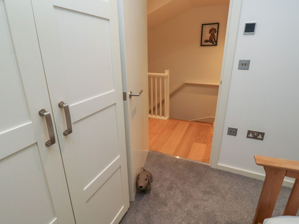 A hallway with doors and a staircase at 8 Pottery Cottages