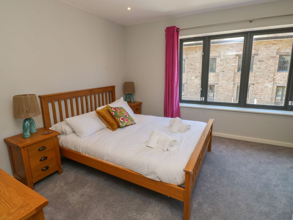 A bedroom with a bed and nightstands at 8 Pottery Cottages
