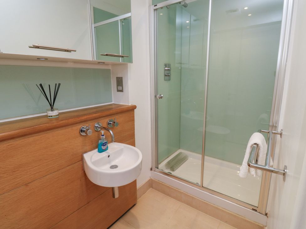 A bathroom with a sink and shower at 8 Pottery Cottages