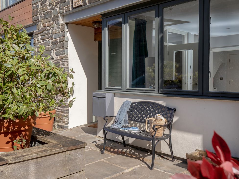 An outdoor area featuring a bench and plants at Mariners Retreat, 8 Pottery Cottages Dartmouth