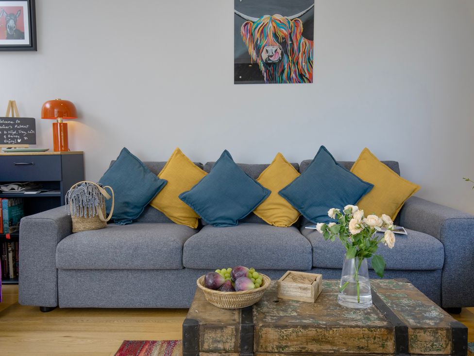 A living room with a sofa and coffee table at Mariners Retreat, 8 Pottery Cottages, Dartmouth