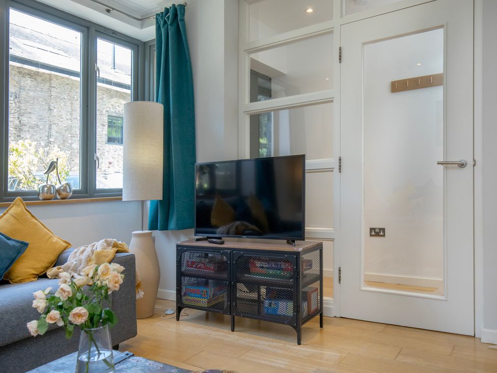 A living room with a television and sofa at Mariners Retreat, 8 Pottery Cottages, Dartmouth