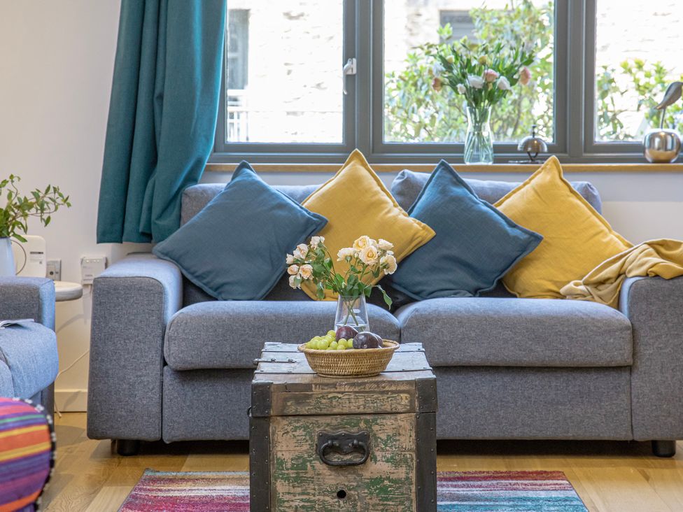A living room with a couch and a coffee table at Mariners Retreat, 8 Pottery Cottages, Dartmouth