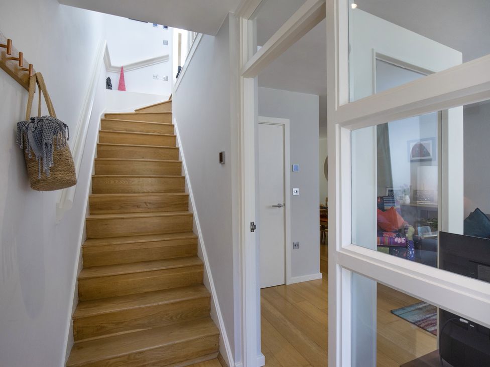 A staircase located in the hallway at Mariners Retreat, 8 Pottery Cottages in Dartmouth