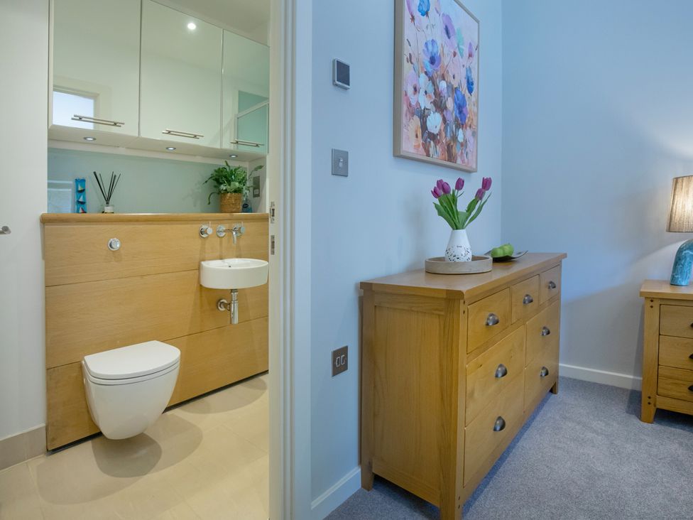 A bathroom with a toilet and sink at Mariners Retreat, 8 Pottery Cottages Dartmoor