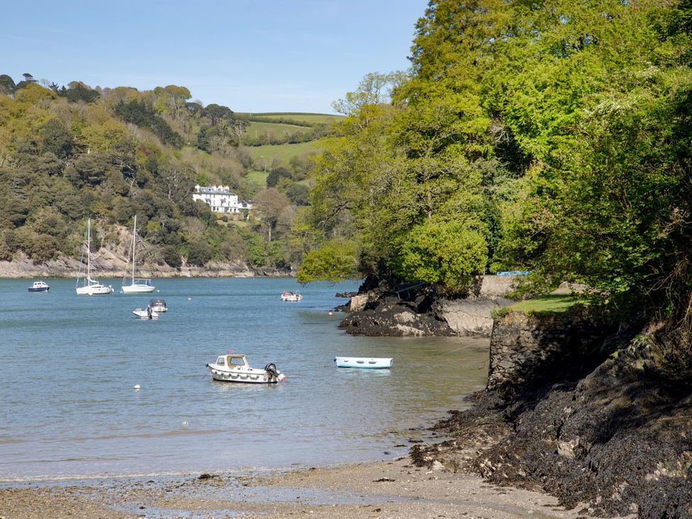 A scenic view of boats on water with trees and a house in the background at Mariners Retreat, 8 Pottery Cottages, Dartmouth