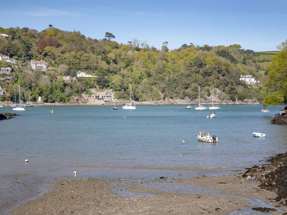 A view of boats on water with trees and houses in the background at Mariners Retreat, 8 Pottery Cottages, Dartmouth