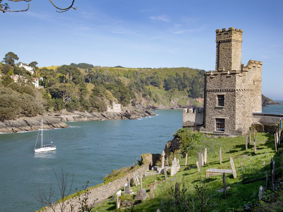 A view of a castle near water with a boat sailing at Mariners Retreat, 8 Pottery Cottages, Dartmouth