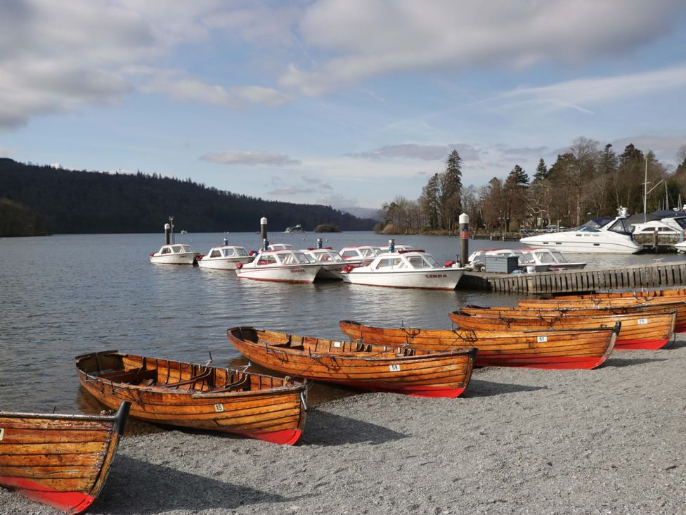 A view of boats at a lake with a gravel beach at Marina View in Bowness-On-Windermere