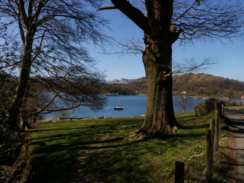 A view of water with boats and trees at Marina View in Bowness-On-Windermere