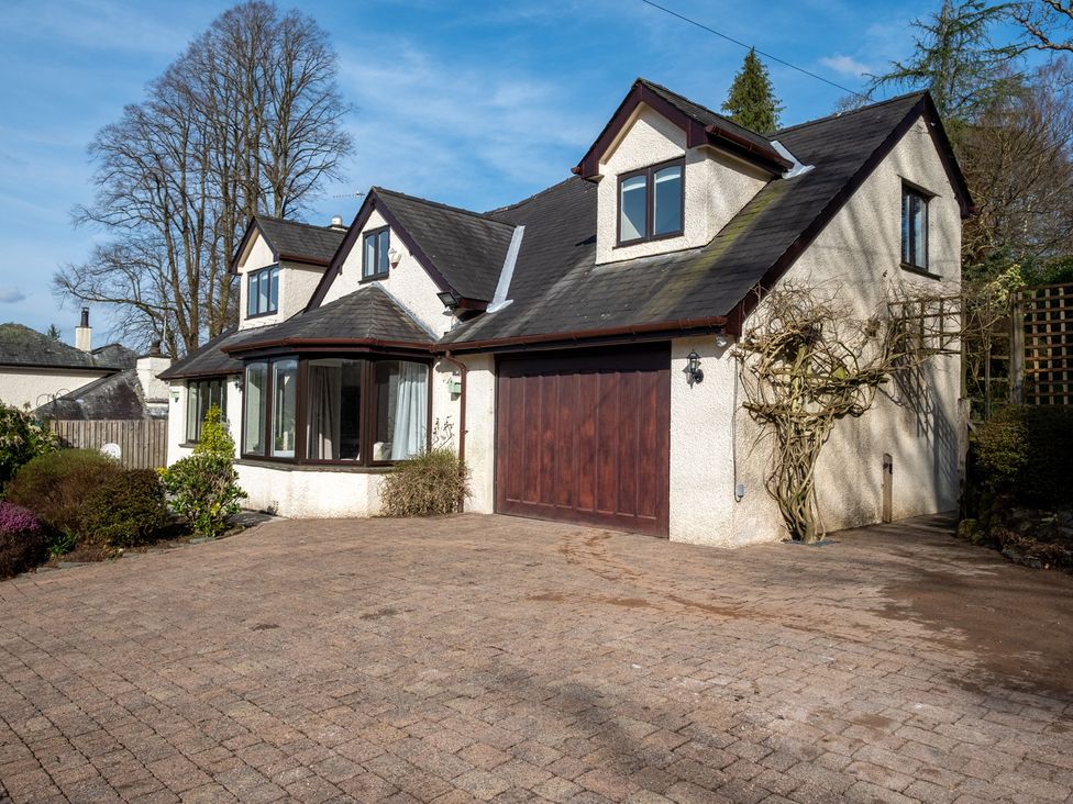 A house with a garage and driveway at Marina View in Bowness-On-Windermere
