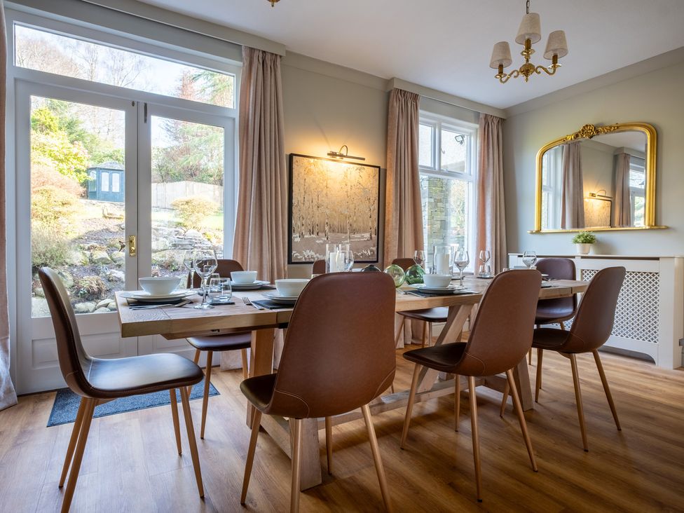 A dining room with a table and chairs at Marina View in Bowness-On-Windermere