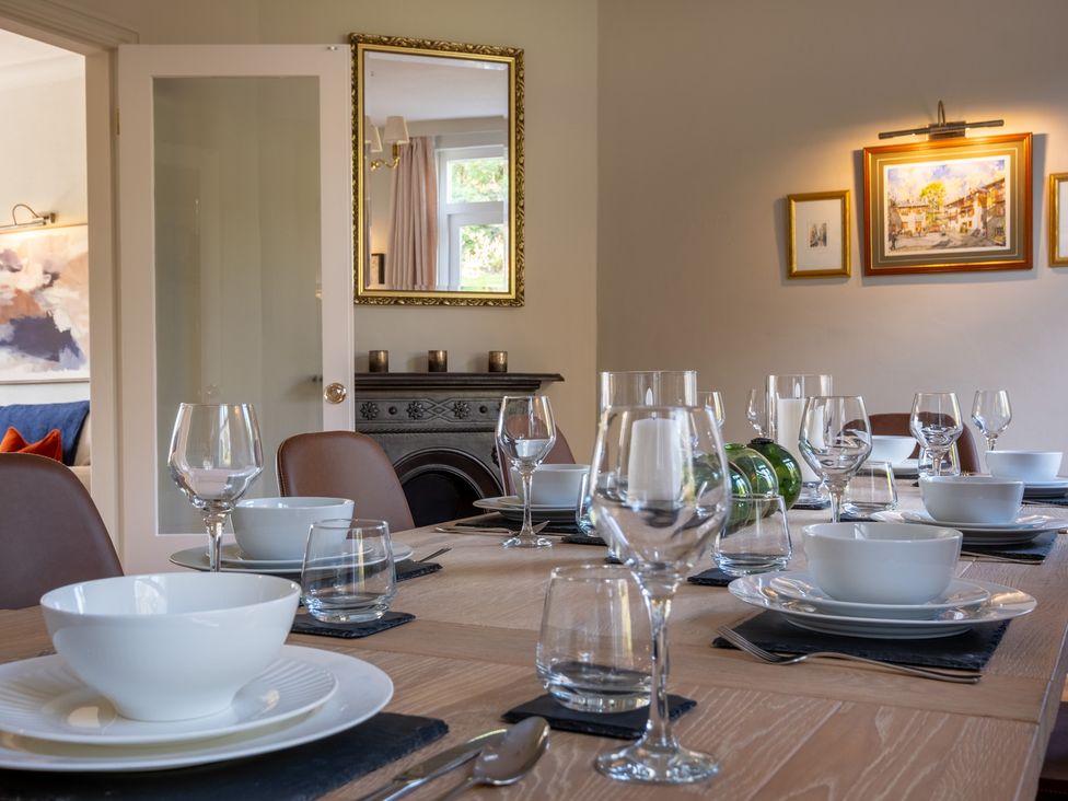 A dining room with a table set for dinner at Marina View in Bowness-On-Windermere