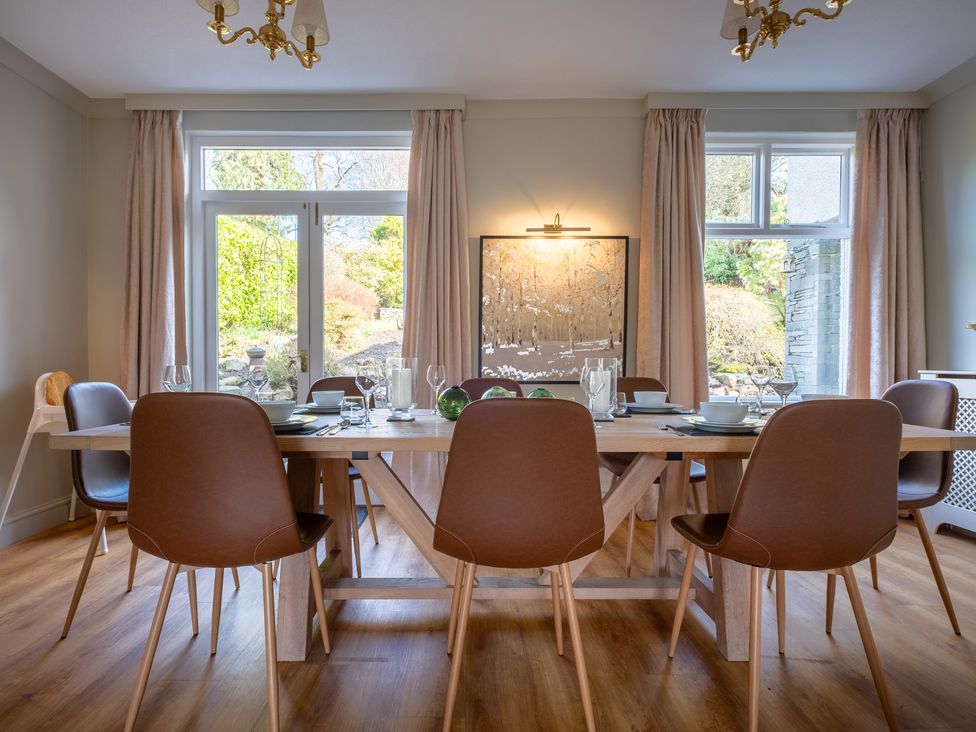 A dining room with a table and chairs at Marina View in Bowness-On-Windermere