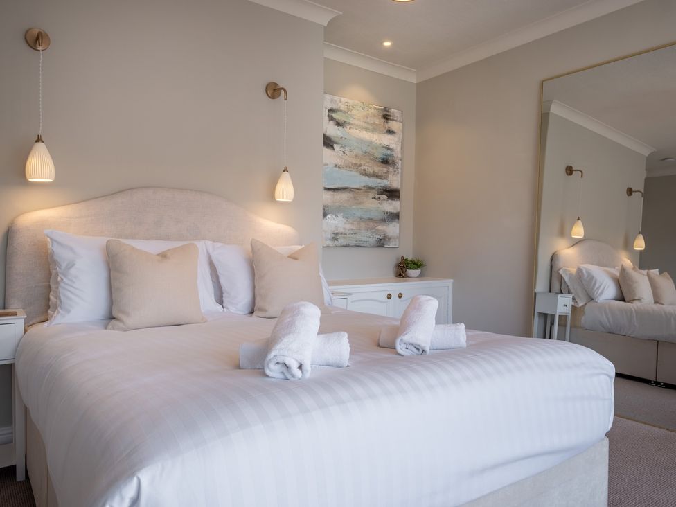 A bedroom with bed and decorative elements at Marina View in Bowness-On-Windermere