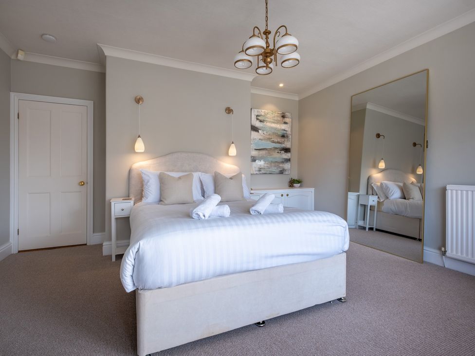 A bedroom with a bed and bedside table at Marina View in Bowness-On-Windermere
