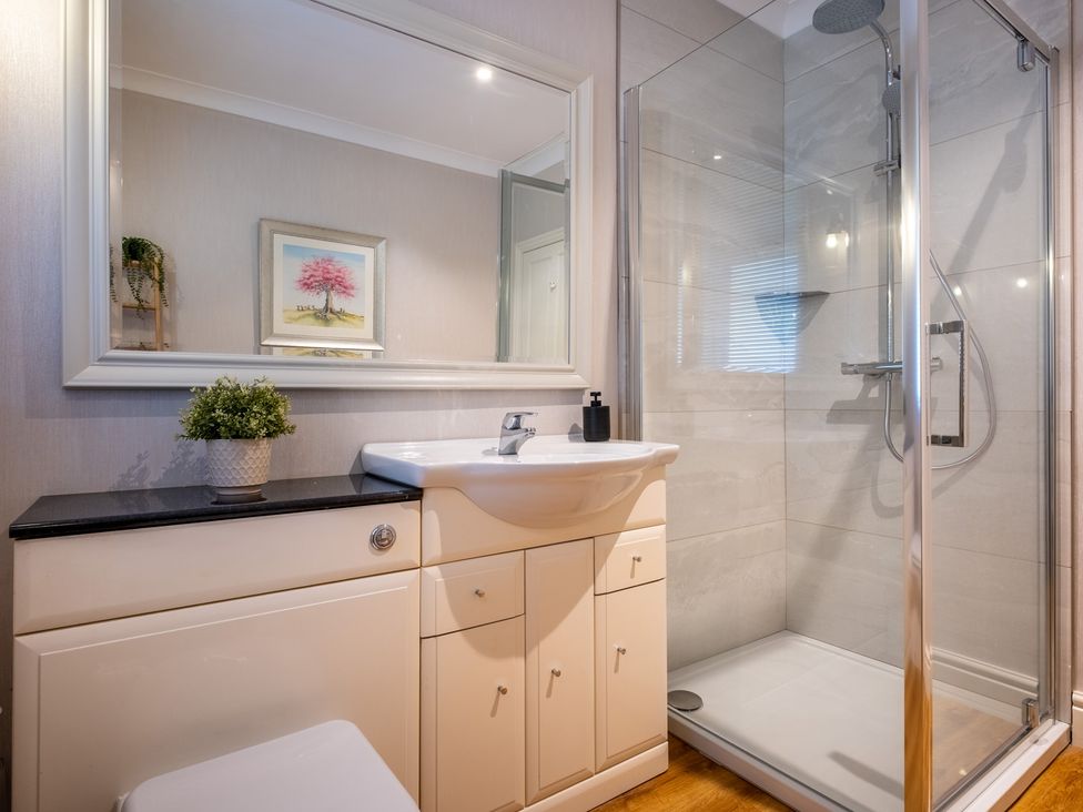 A bathroom with a sink and shower at Marina View in Bowness-On-Windermere