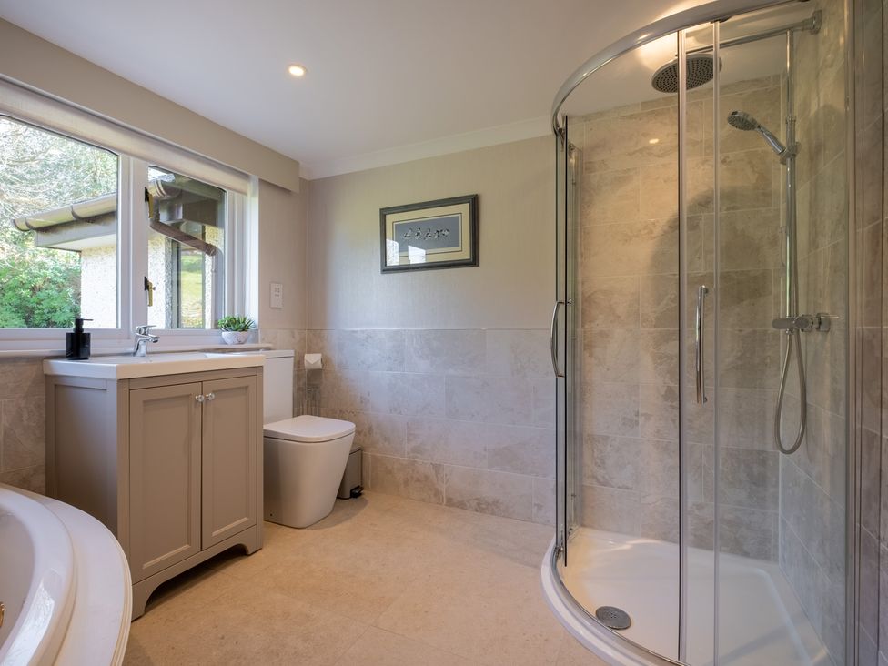 A bathroom with a shower and vanity at Marina View in Bowness-On-Windermere