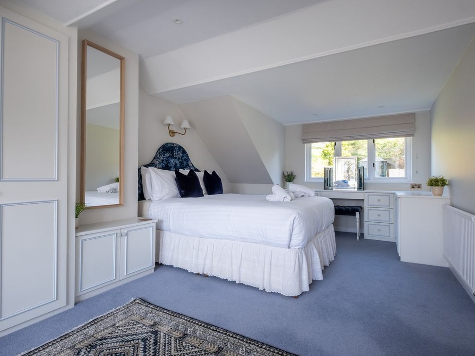 A bedroom with a bed and desk at Marina View in Bowness-On-Windermere