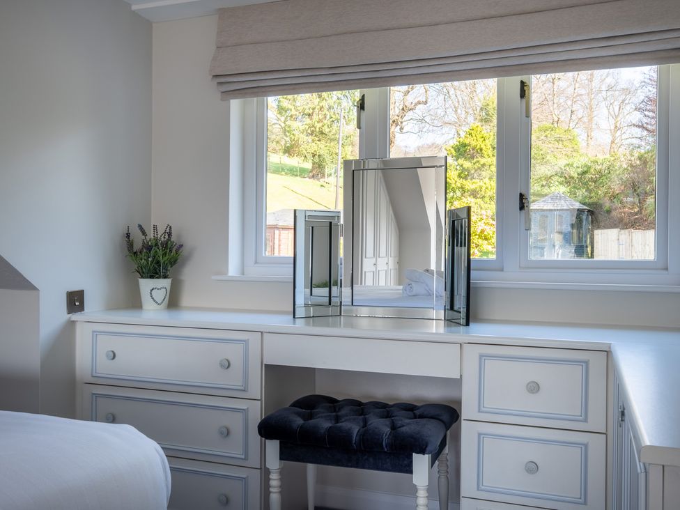 A bedroom with a dressing table and mirror at Marina View in Bowness-On-Windermere