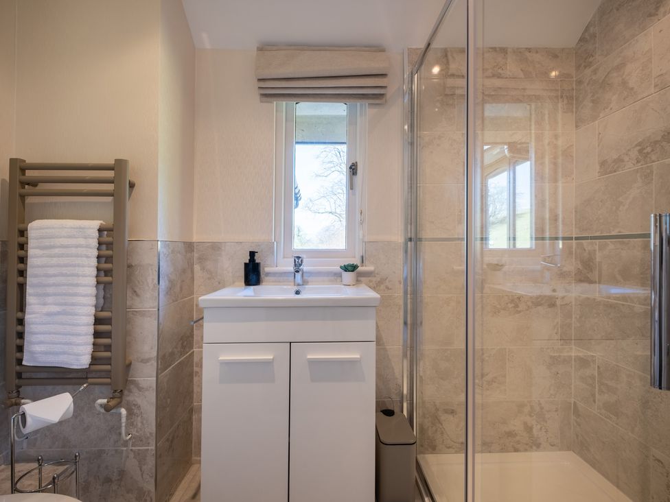 A bathroom with a shower and sink at Marina View in Bowness-On-Windermere